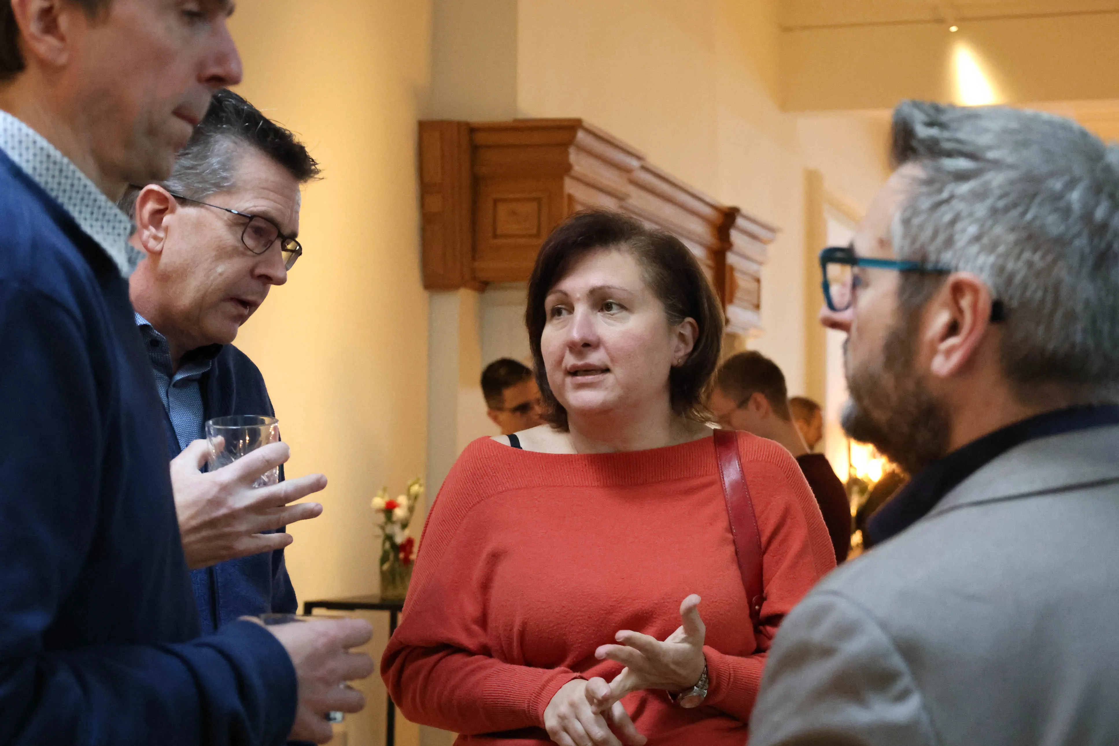 Group of adults engaged in a conversation at an IMUG event