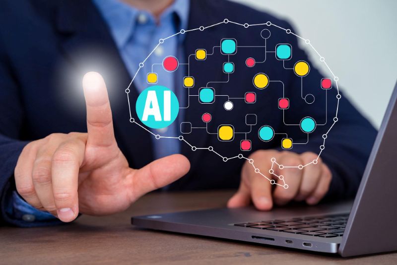 Brain outline with colourful connector dot and finger pointing to the word "AI".
