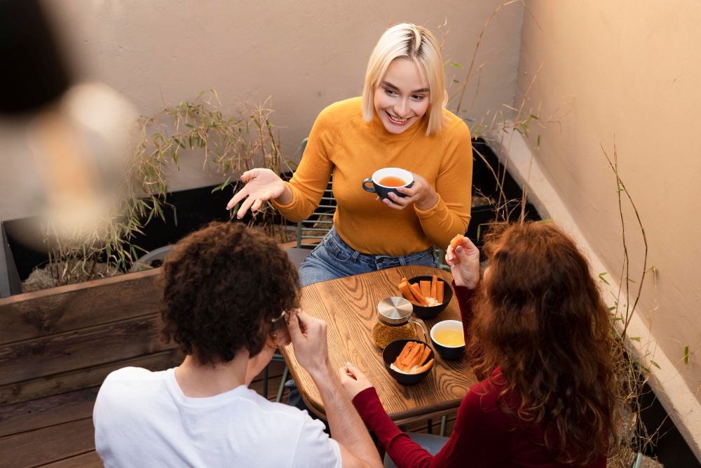 Close up of three friends at a cafe table