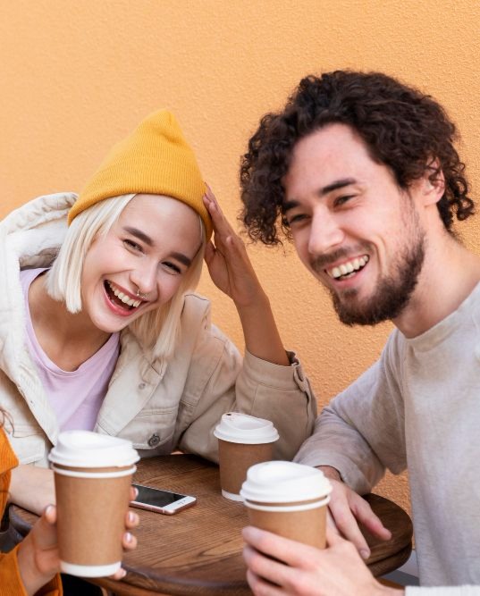Three fiends and a cafe drinking coffee