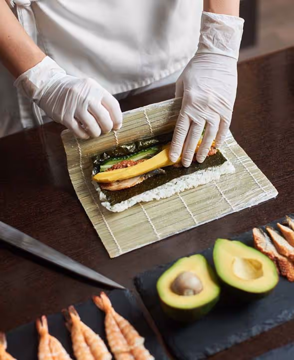a chef making a sushi roll
