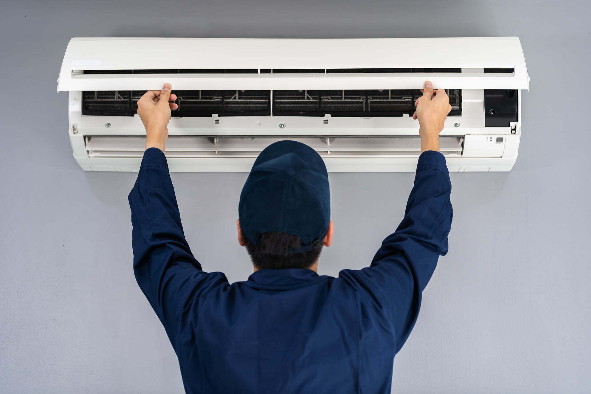 hvac technician putting in an air conditioner