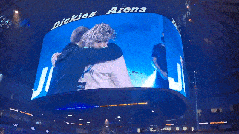 Video running on the large screen inside Dickies Arena during an event.