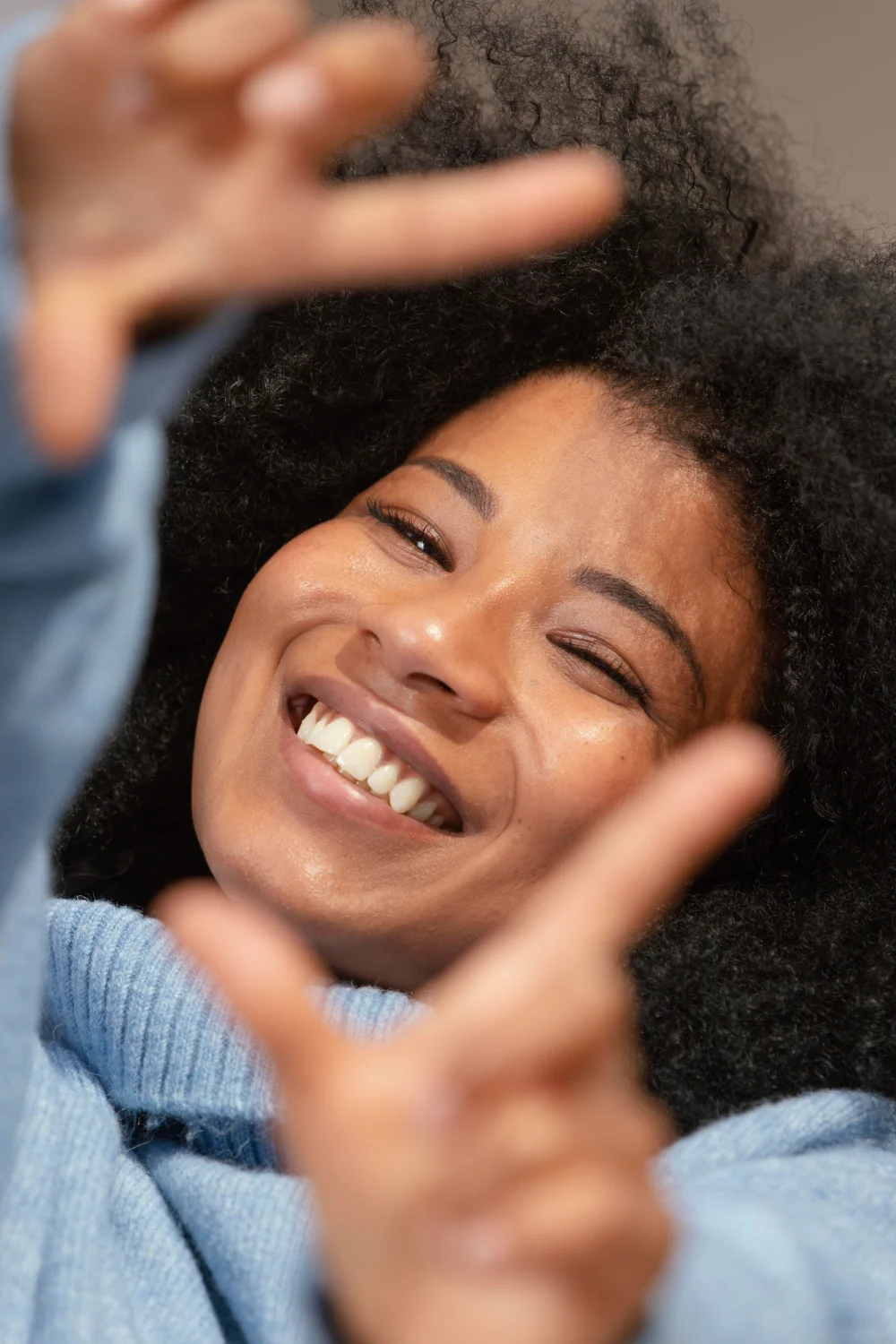 A woman making a gesture with her hands.