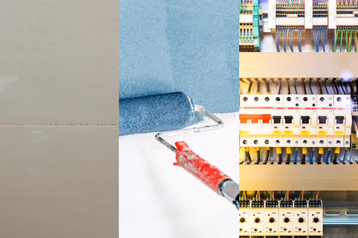 Un rouleau de peinture appliquant de la peinture bleue sur un mur blanc, à côté d'un tableau électrique avec des disjoncteurs et des câbles colorés.
