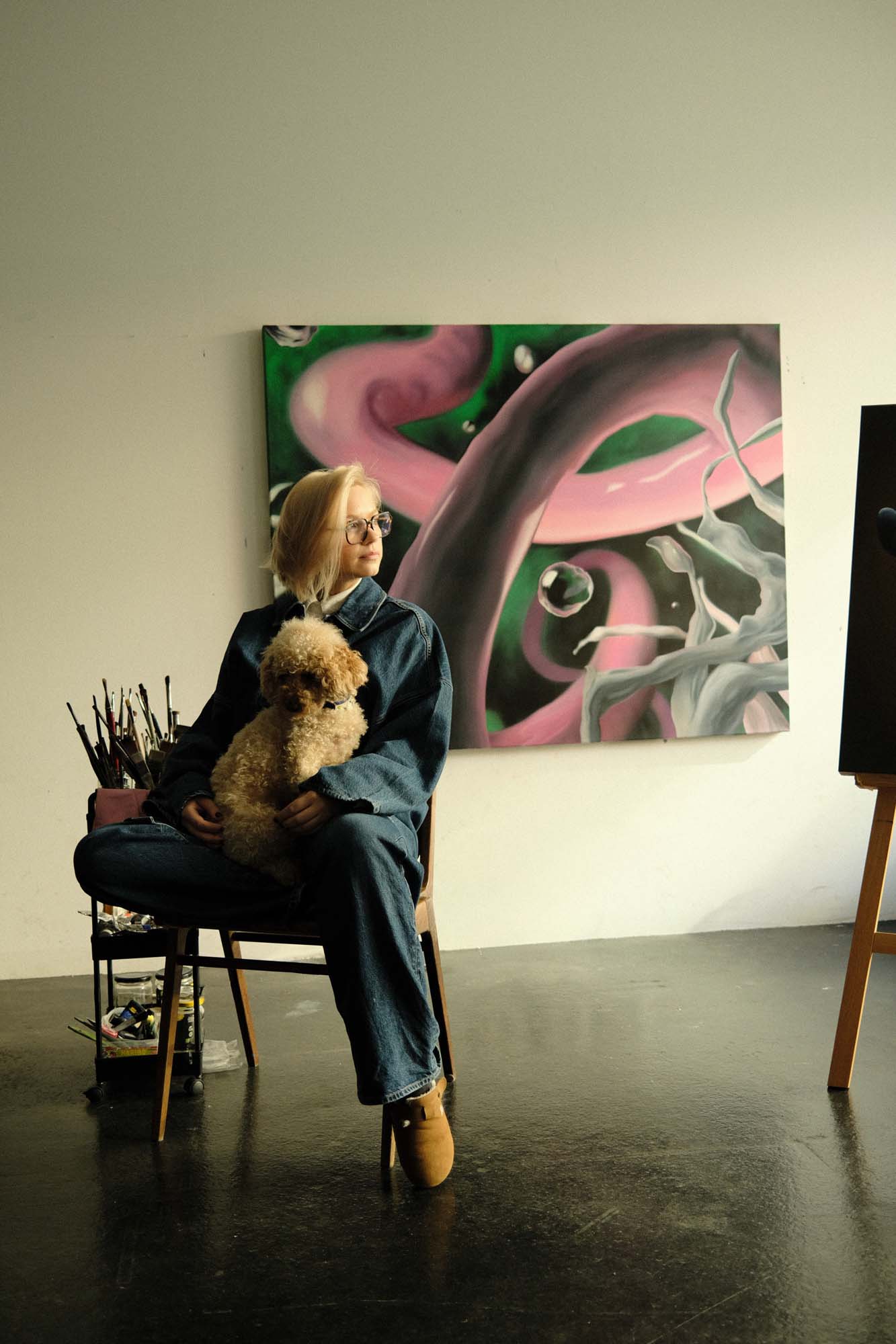 female artist sitting in gallery space