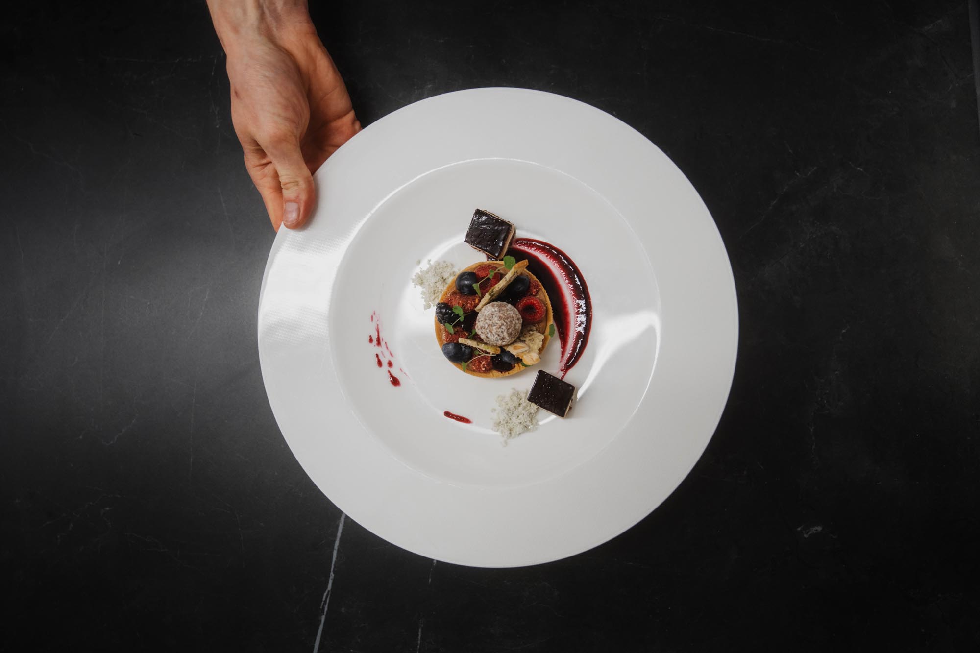 fine dining dish plated on white plate in soft light