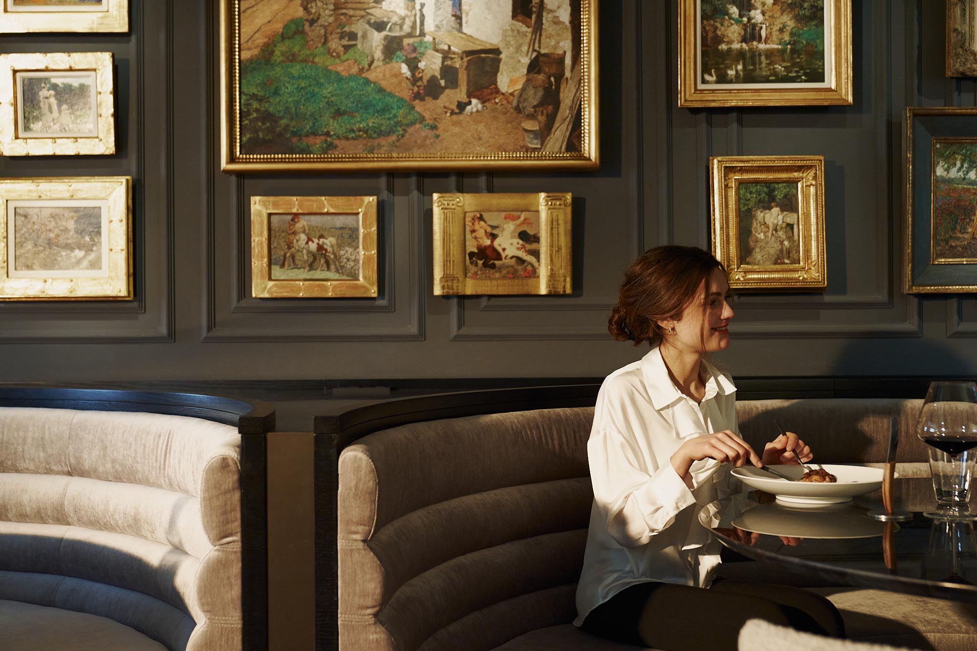 person sitting at a table in a luxury hotel restaurant