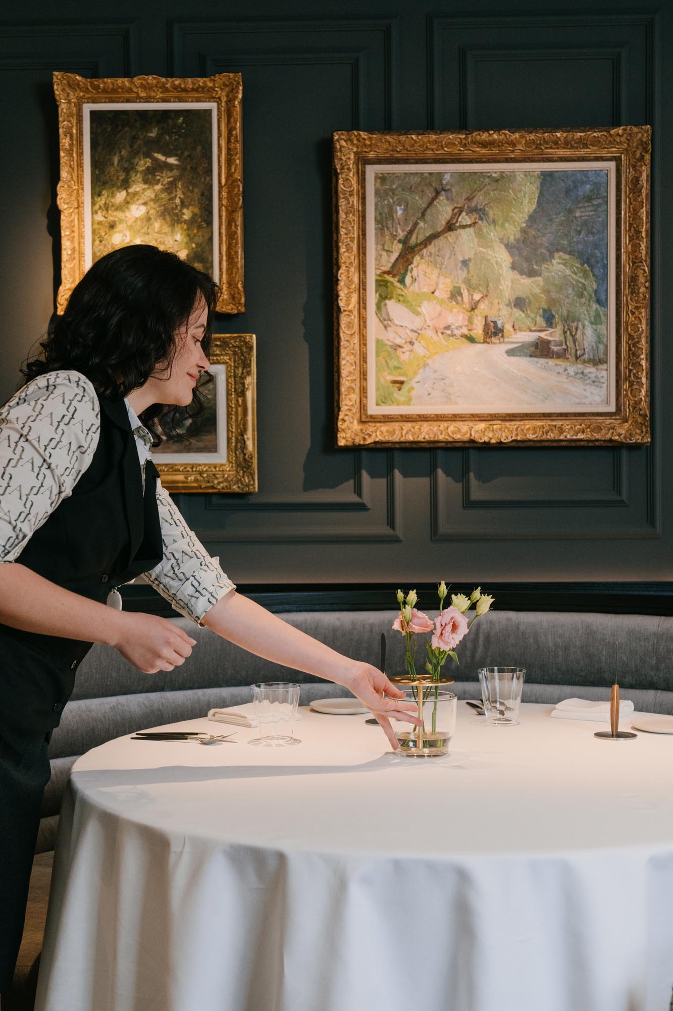 restaurant service moment with table setting and artwork