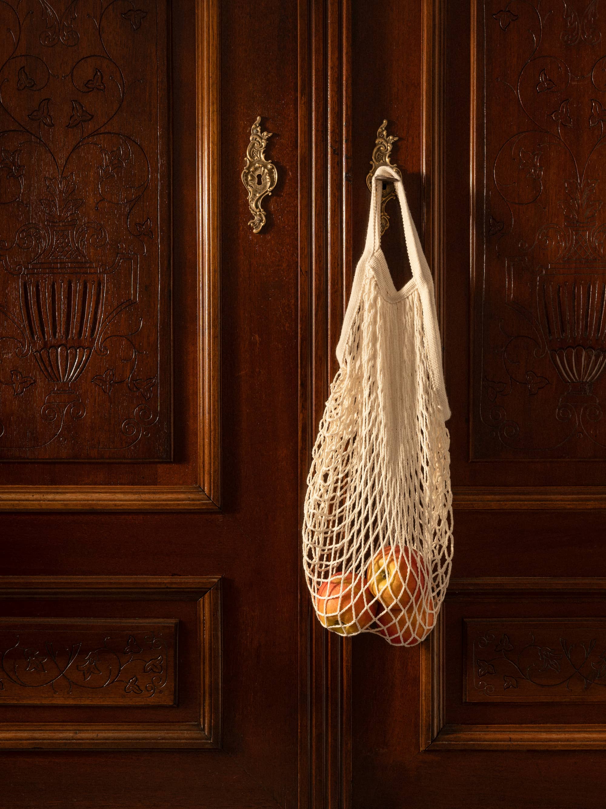 hanging bag on wooden door in warm tones