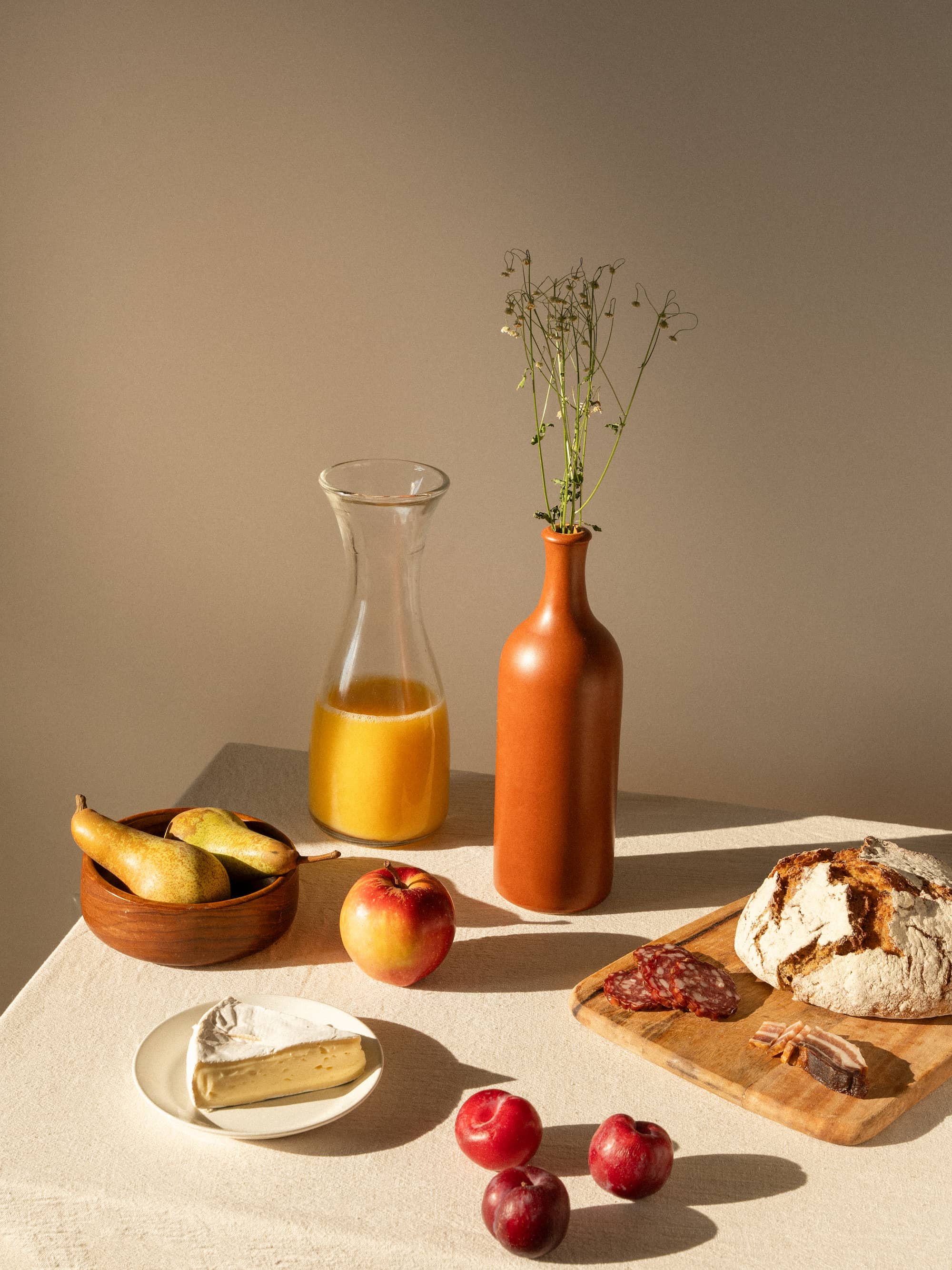 breakfast table setup with juice and pastries