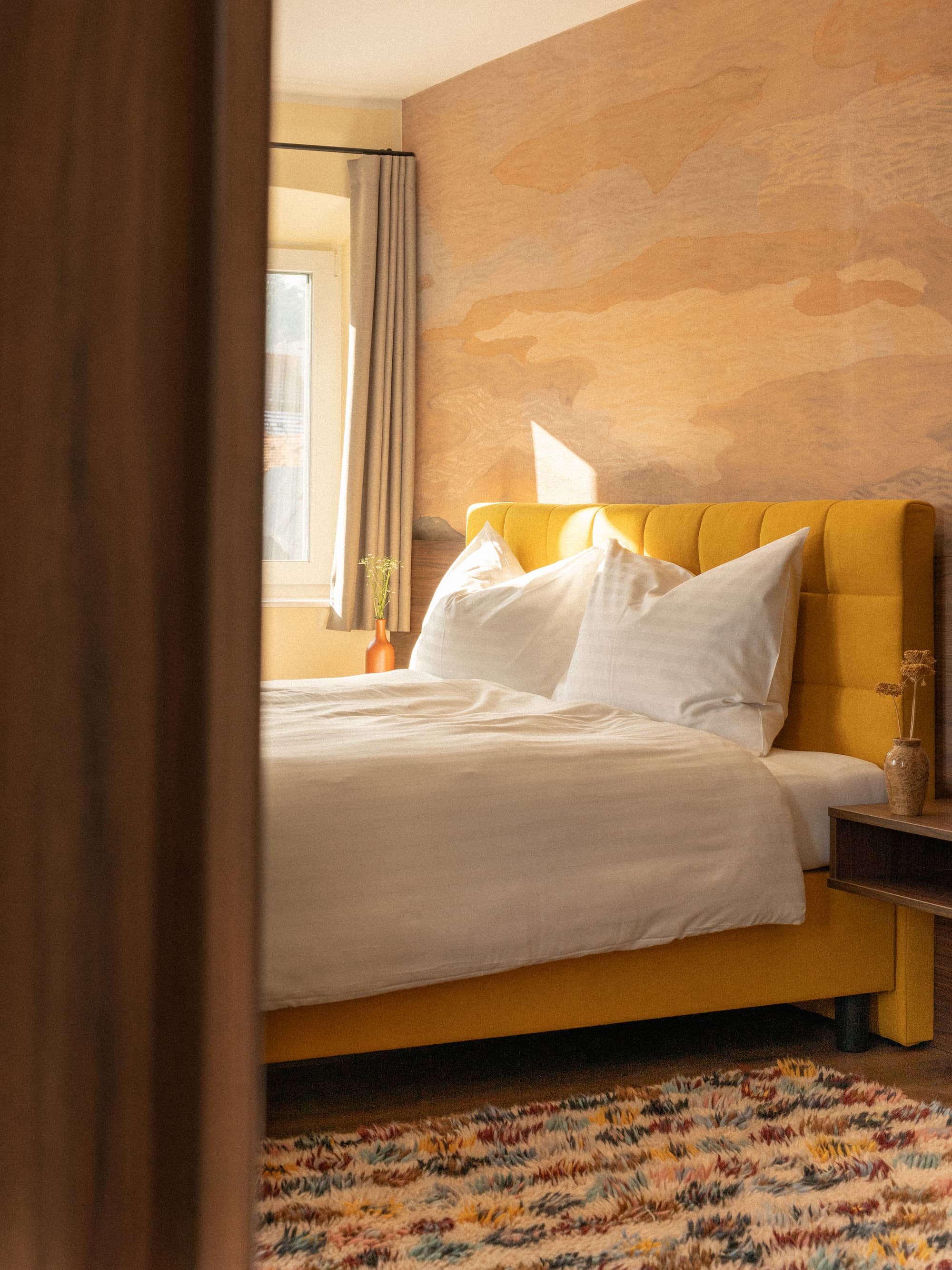 boutique hotel bedroom seen through doorway