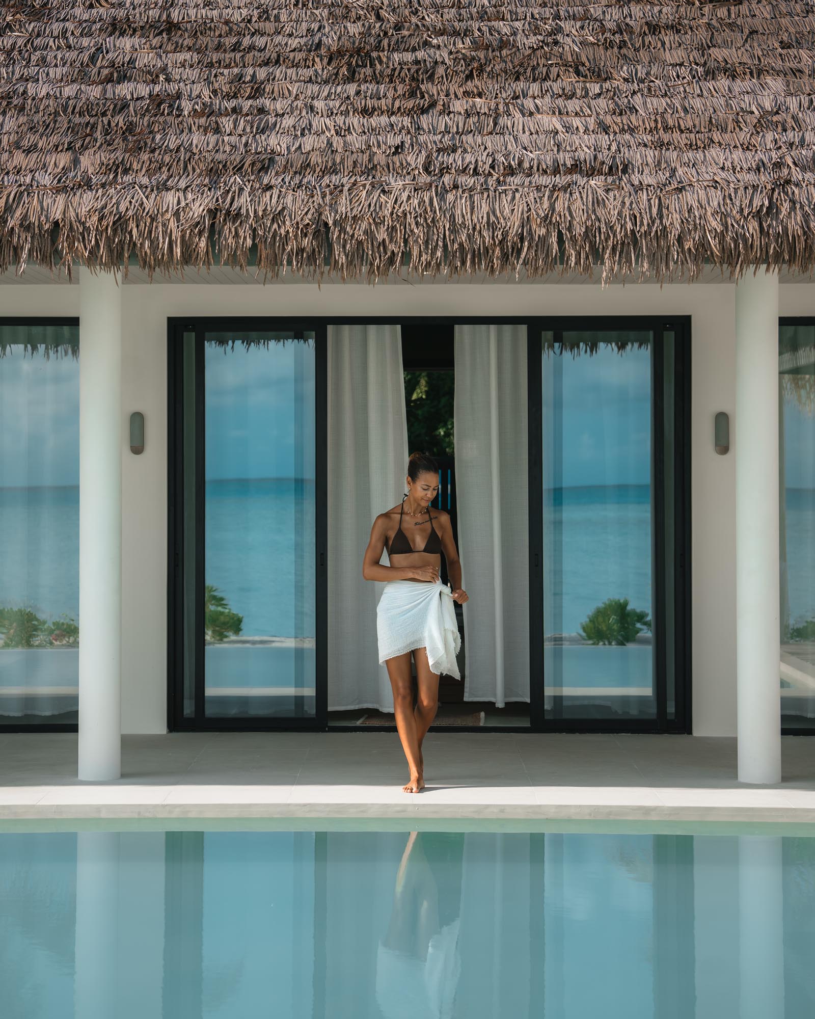 guest standing by private pool villa at luxury hotel
