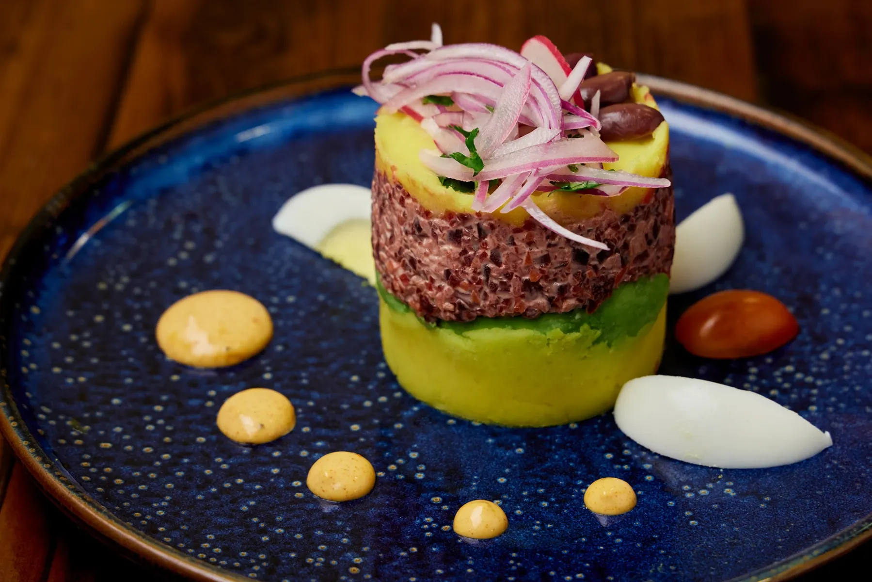 Causa Santa Rosa: Beet salad, carrot, apples, avocado, olives, tomato, egg, salsa criolla, micro greens.