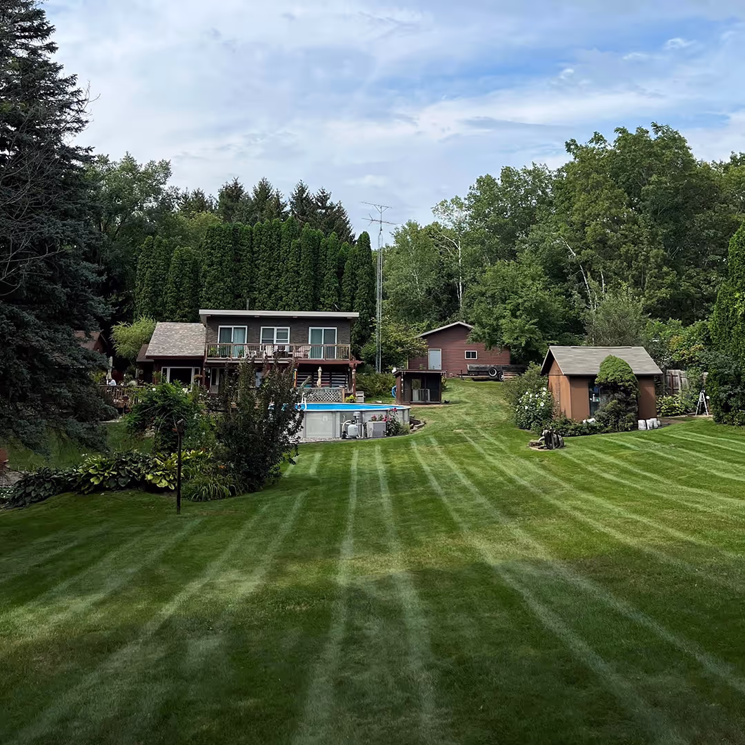 Lawn mowing results with bold stripes near me Yellow Birch Landscaping