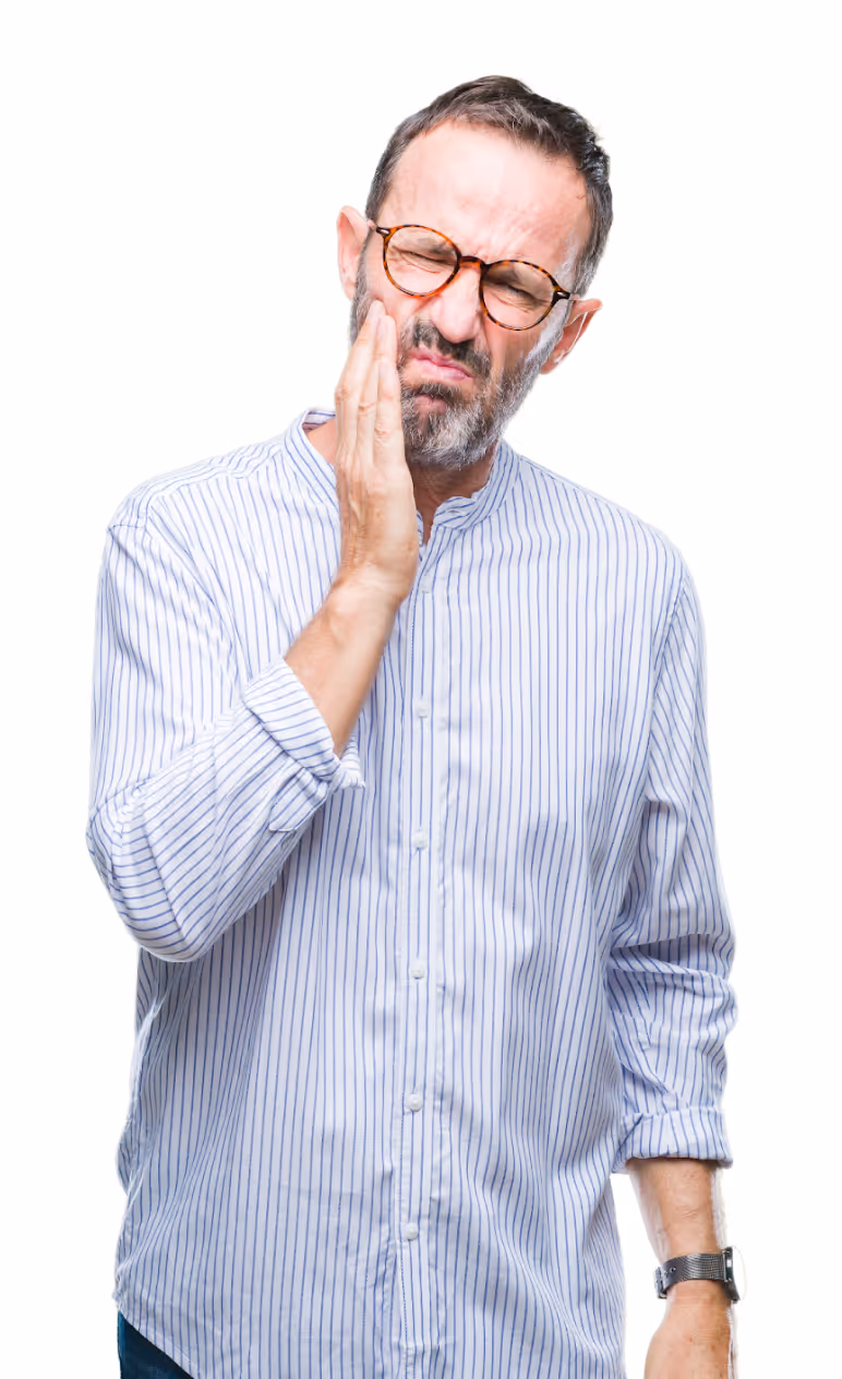 Man holding his cheek with a painful expression, indicating toothache or dental discomfort