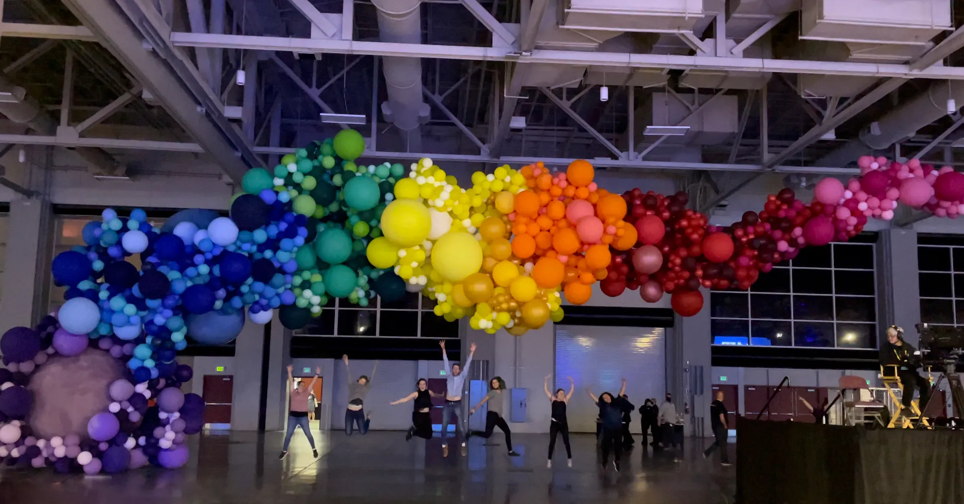 A large rainbow balloon art installation created by Balloon Artisan.