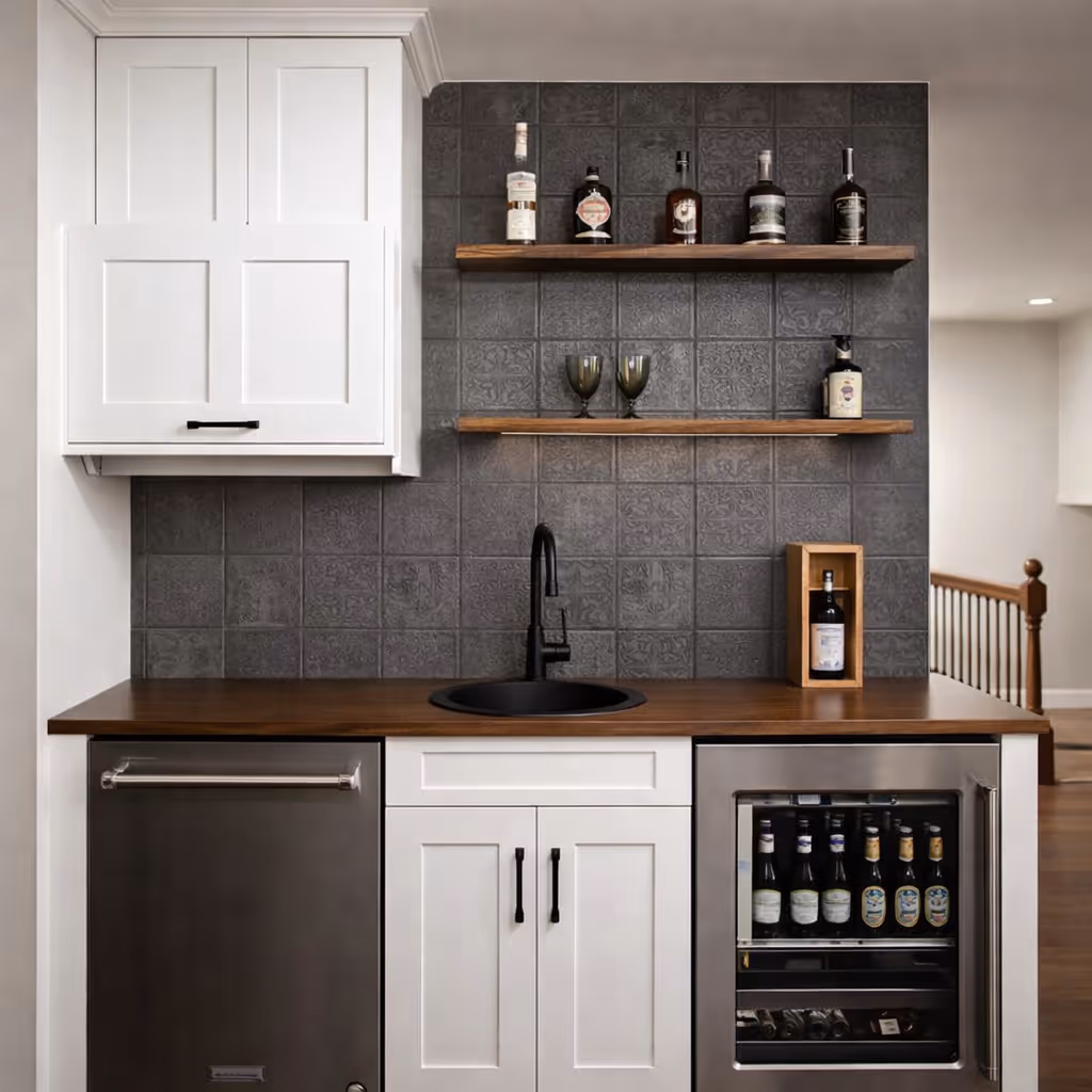 Modern home bar area with white cabinets, dark patterned tile backsplash, wood countertop, black sink faucet, floating shelves with liquor bottles, and built-in beverage fridge.