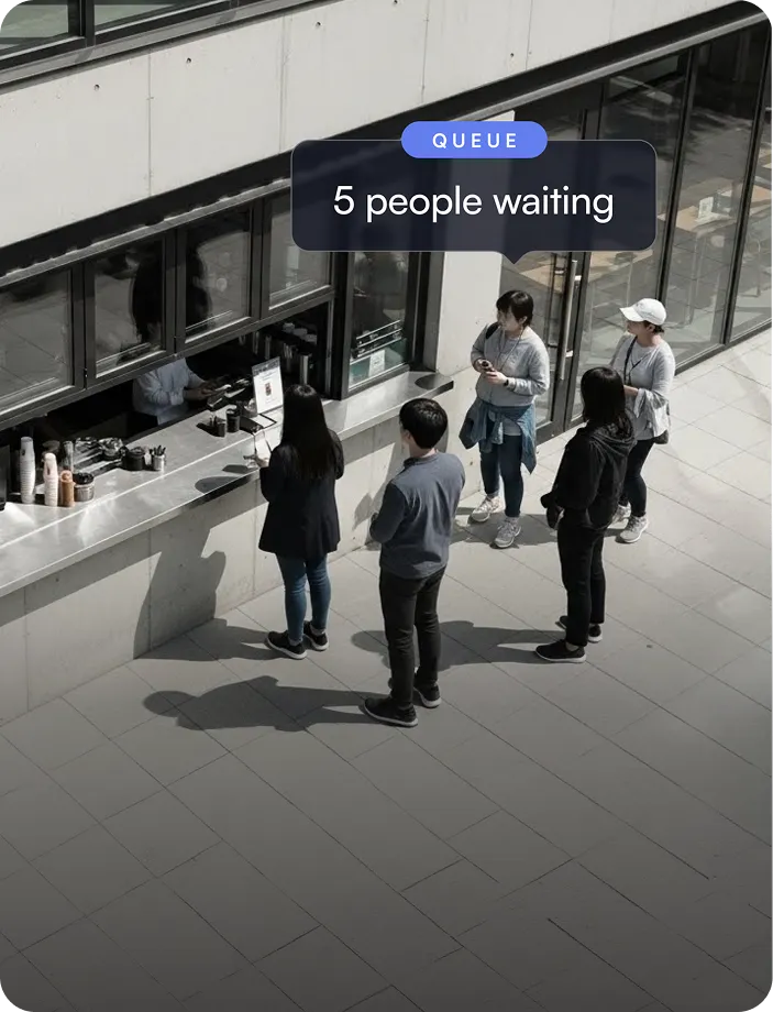 Five people standing in line outdoors at a service window with a sign indicating 'QUEUE 5 people waiting.'