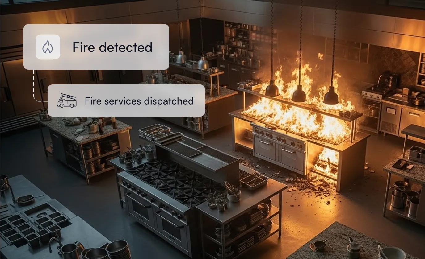 Commercial kitchen stove engulfed in flames with alerts indicating fire detected and fire services dispatched.