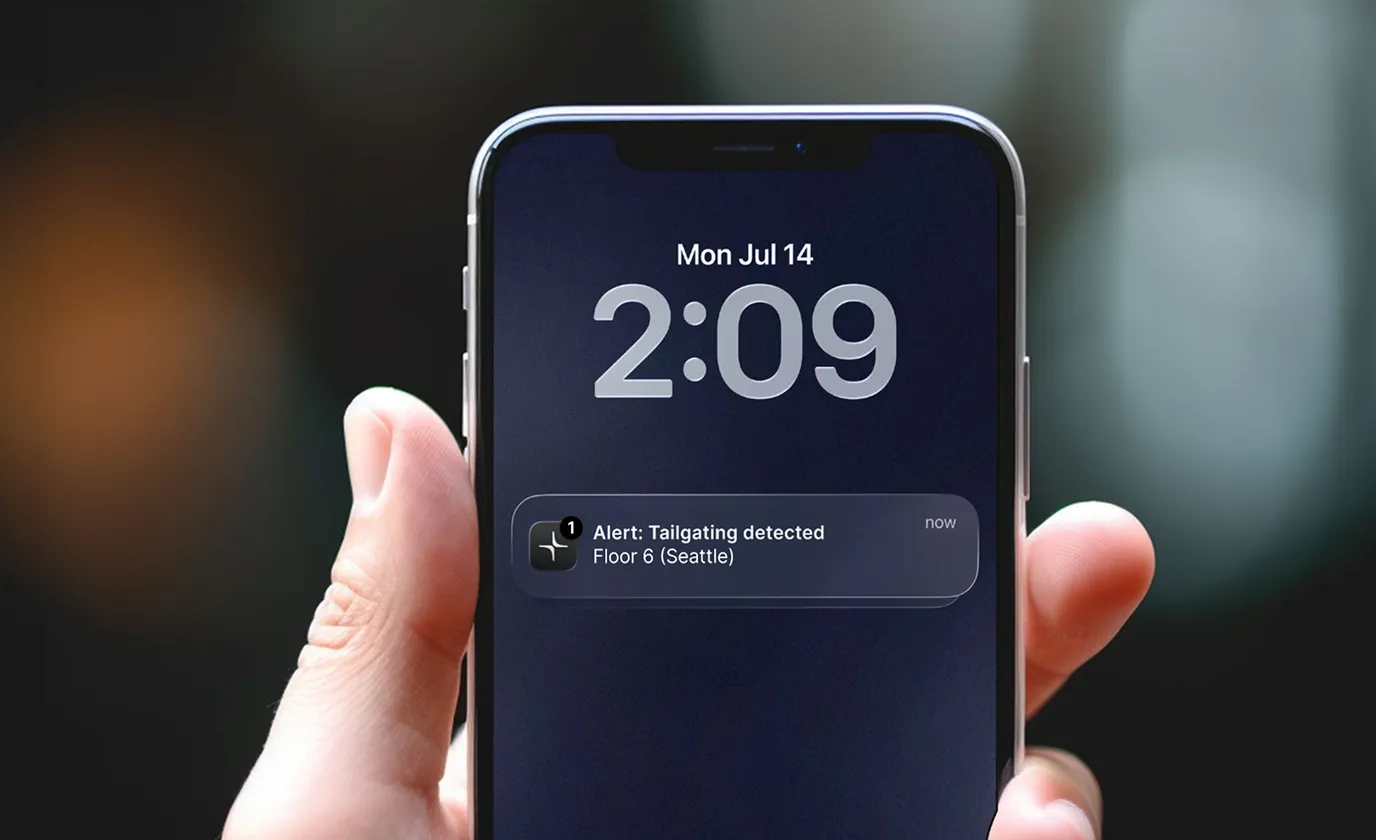 Smartphone lock screen showing time 2:09 on Monday, July 14, with a notification alert reading 'Tailgating detected, Floor 6 (Seattle)'.