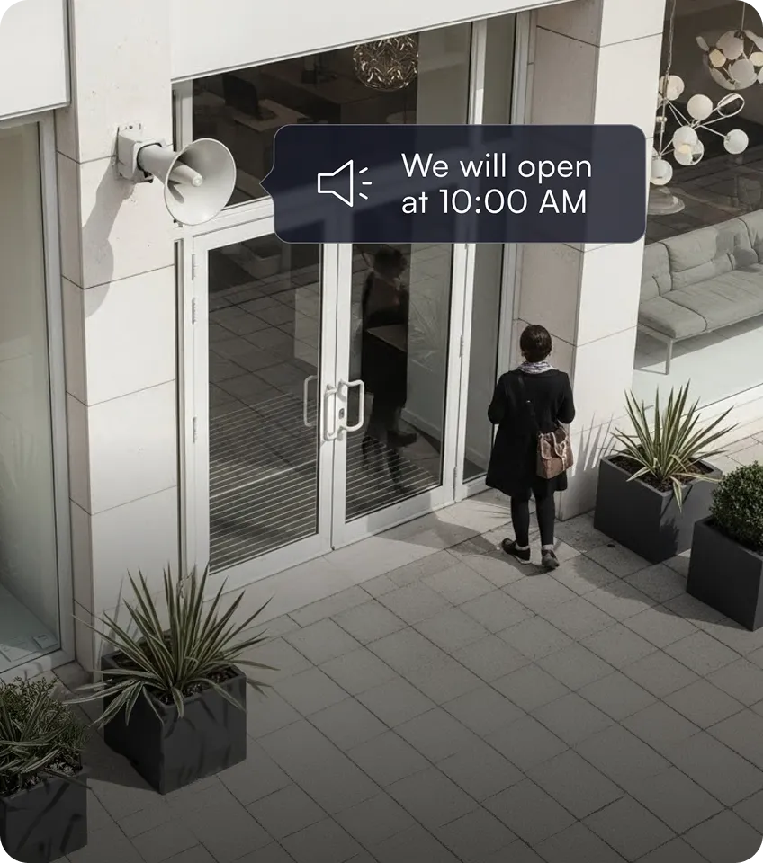 Person standing outside a glass door entrance with a sign saying 'We will open at 10:00 AM'.