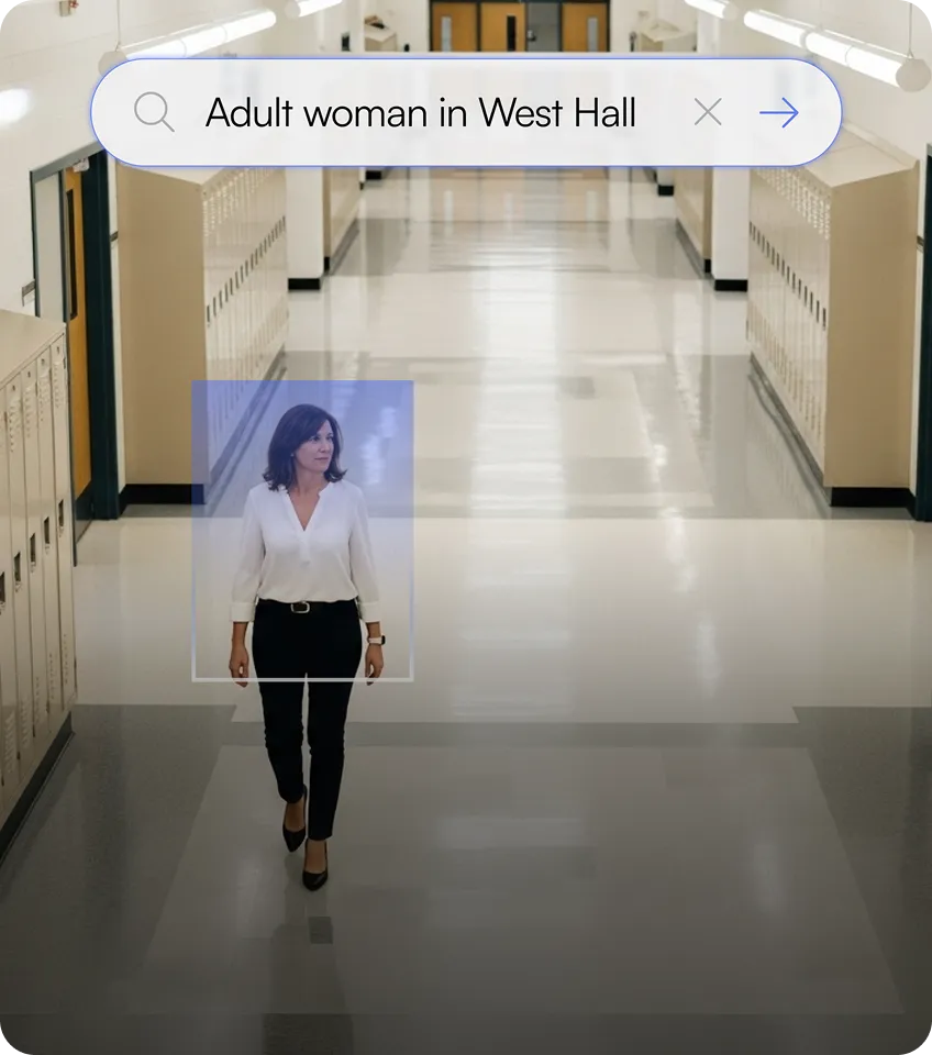Adult woman walking in a school hallway with lockers, highlighted by a search box labeled 'Adult woman in West Hall'.