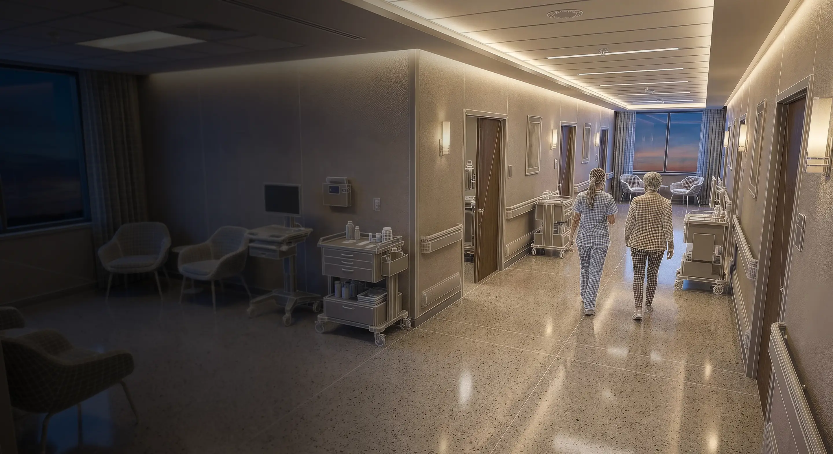 Corridor in a healthcare facility with two medical staff walking away, surrounded by medical carts and seating areas.