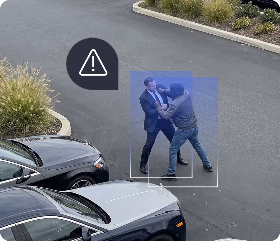Two men fighting in a parking lot, one wearing a suit and the other a hoodie, with an exclamation warning icon nearby.