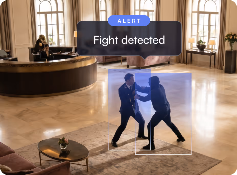 Security alert showing two men fighting in a hotel lobby near a reception desk.