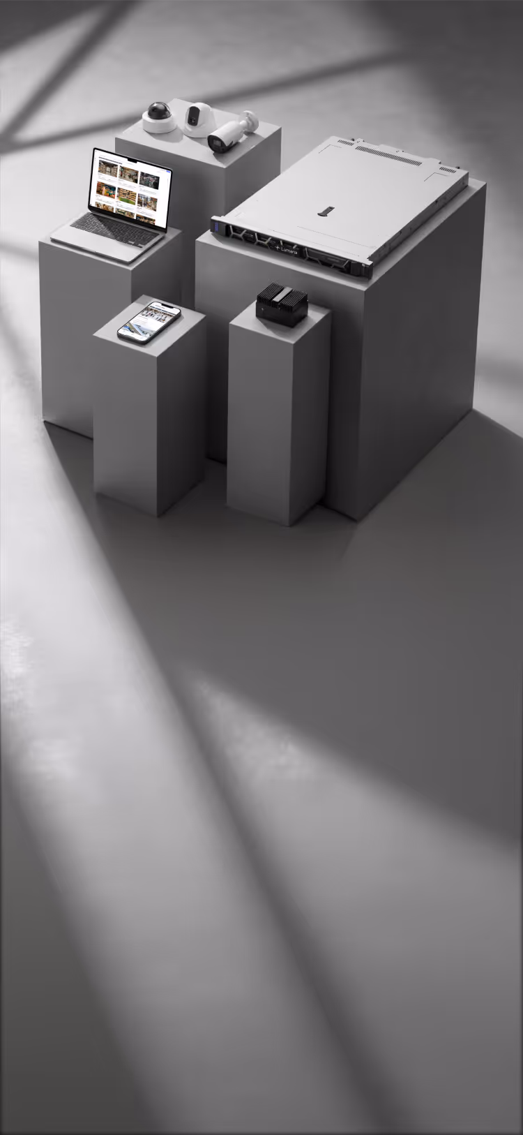 Security cameras, laptop, smartphone, and server hardware displayed on gray pedestals with shadows.