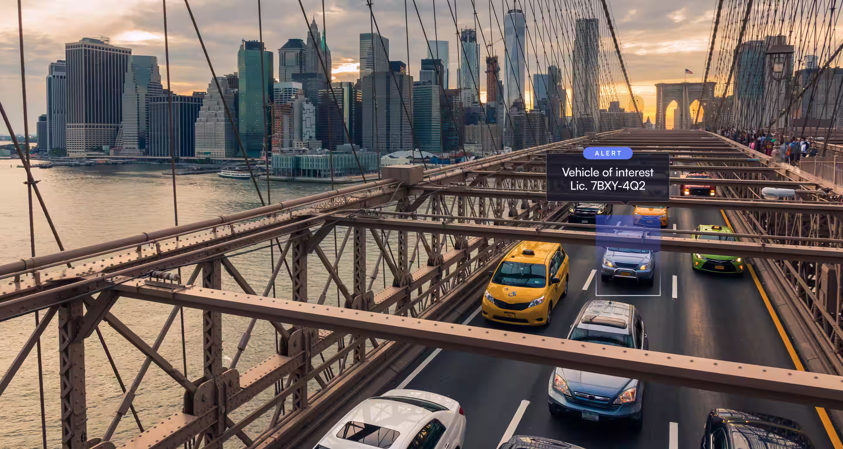 Cars, including taxis, crossing Brooklyn Bridge with alert identifying a vehicle of interest.