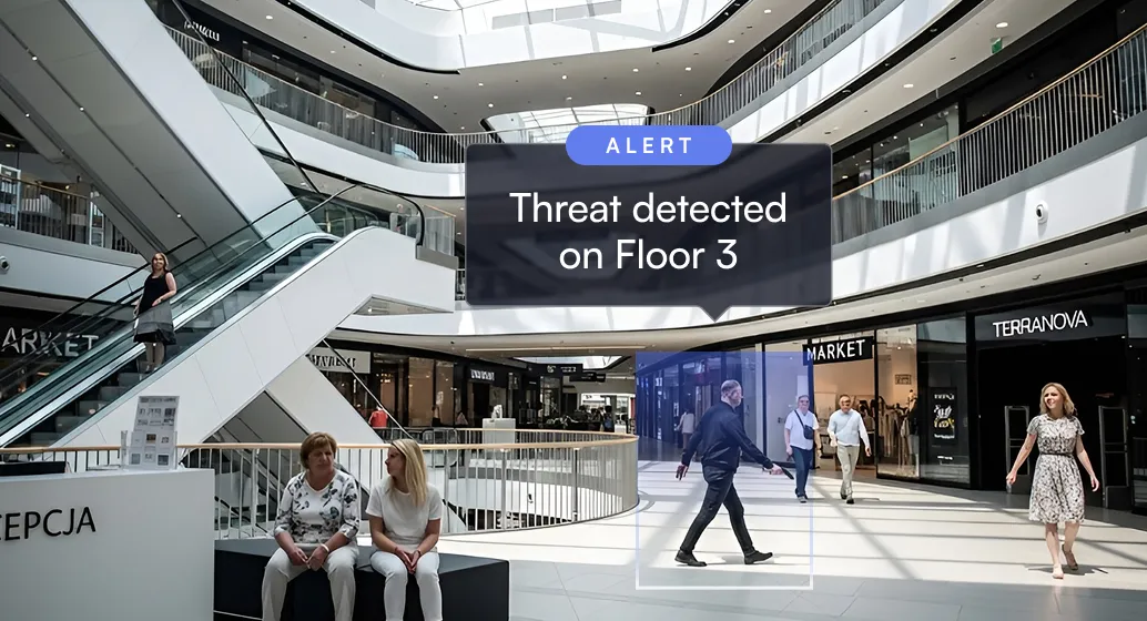 Shopping mall interior with people, escalator, and alert message about threat detected on floor 3.