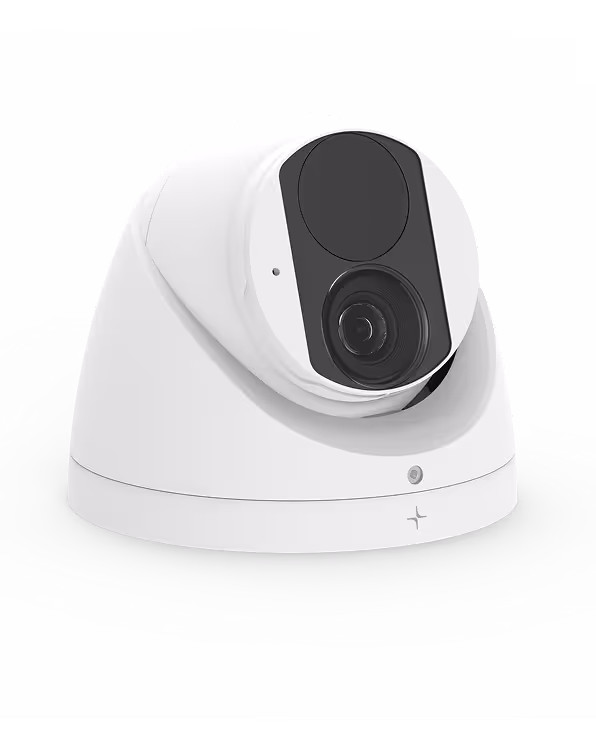 White dome security camera with black faceplate and visible lens on a white surface.