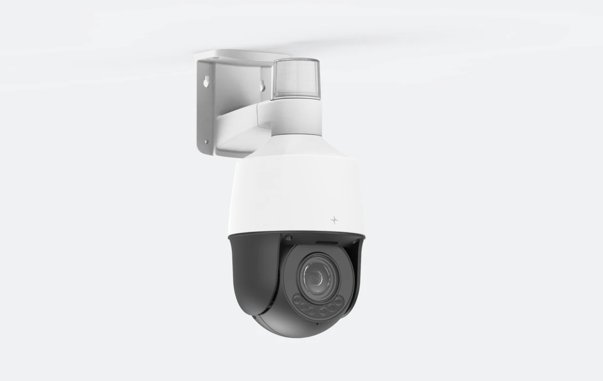 White and black PTZ security camera mounted on a white wall bracket.