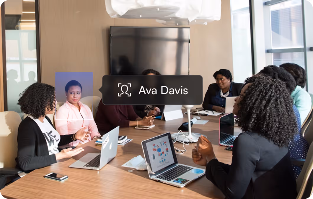 Group of women in a meeting room, with one identified as Ava Davis by facial recognition overlay.