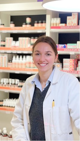 Smiling professional in white lab coat standing in pharmacy or cosmetic store