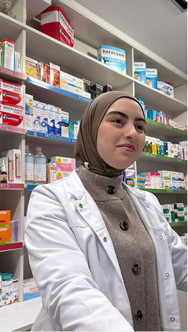 Pharmacist in white coat standing in pharmacy with shelves of medications