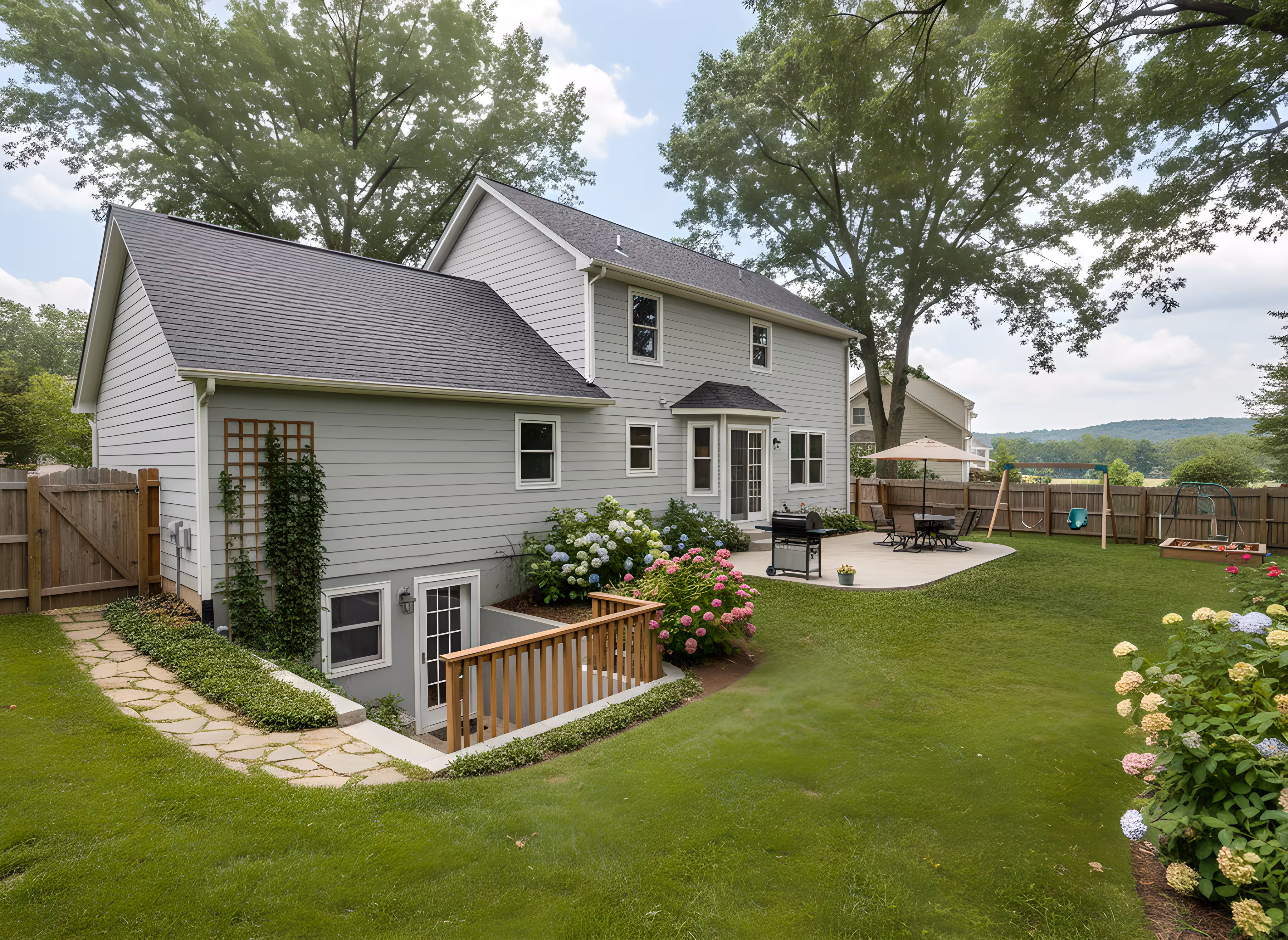 Large brick and stone mansion with multiple windows, surrounded by tall pine trees and landscaping.