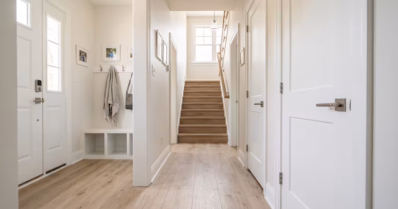 suburban home entry with updated door handles, nonslip flooring and handrail along the stairs