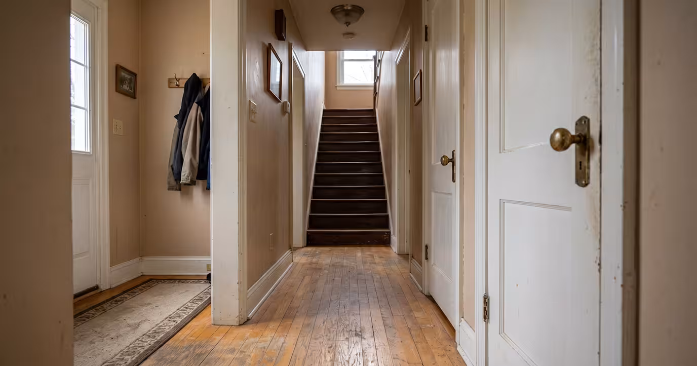 dated home entry with round doorknobs, and dangerous stairs and floors