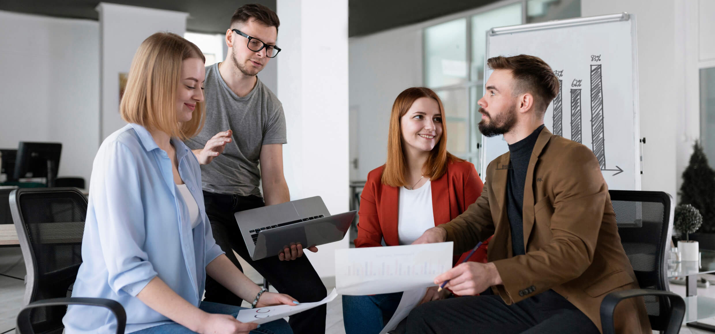 A group of people sitting around each other.