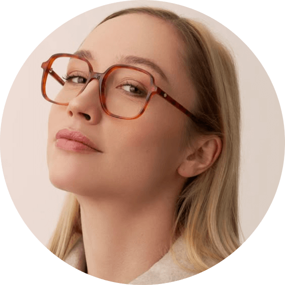 A woman wearing glasses looking up into the sky.