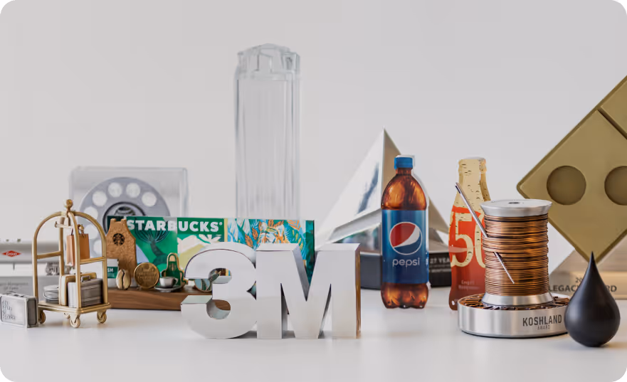 Collection of diverse branded objects including a silver 3M logo, a Starbucks card, a Pepsi bottle, and a spool of copper wire arranged on a white surface.