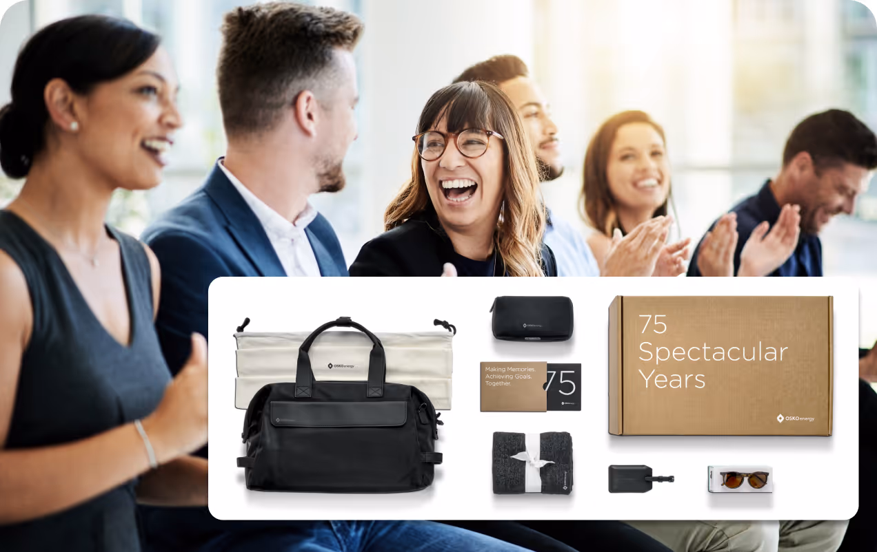 Group of diverse coworkers smiling and clapping with a superimposed image of a gift set including a black bag, blanket, sunglasses, and a box labeled '75 Spectacular Years'.