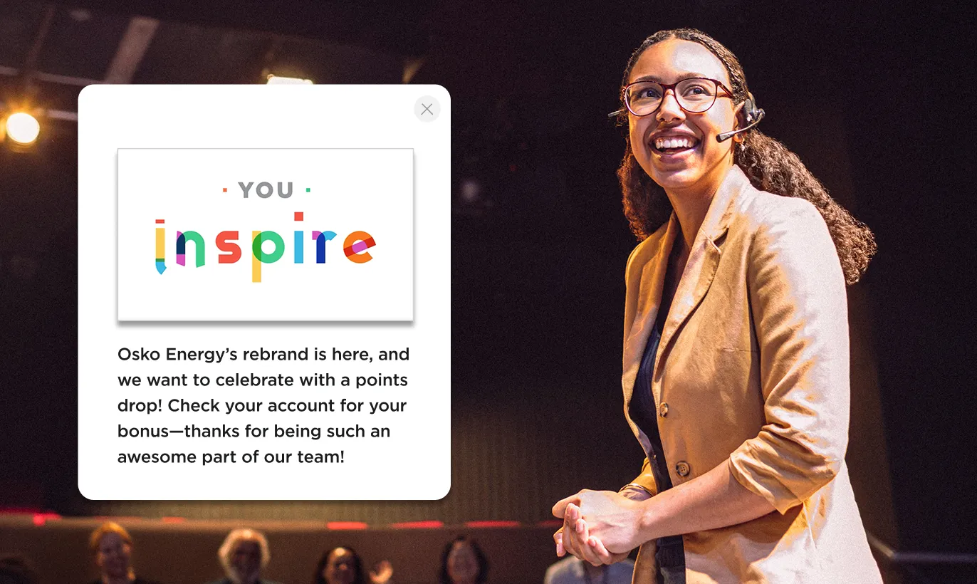Smiling woman with glasses and a headset next to a message about Osko Energy's rebrand and points bonus, featuring colorful 'YOU inspire' text.
