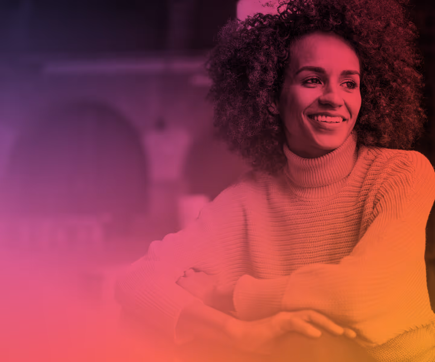 Smiling woman with curly hair wearing a turtleneck sweater looking to the side with a colorful gradient overlay.