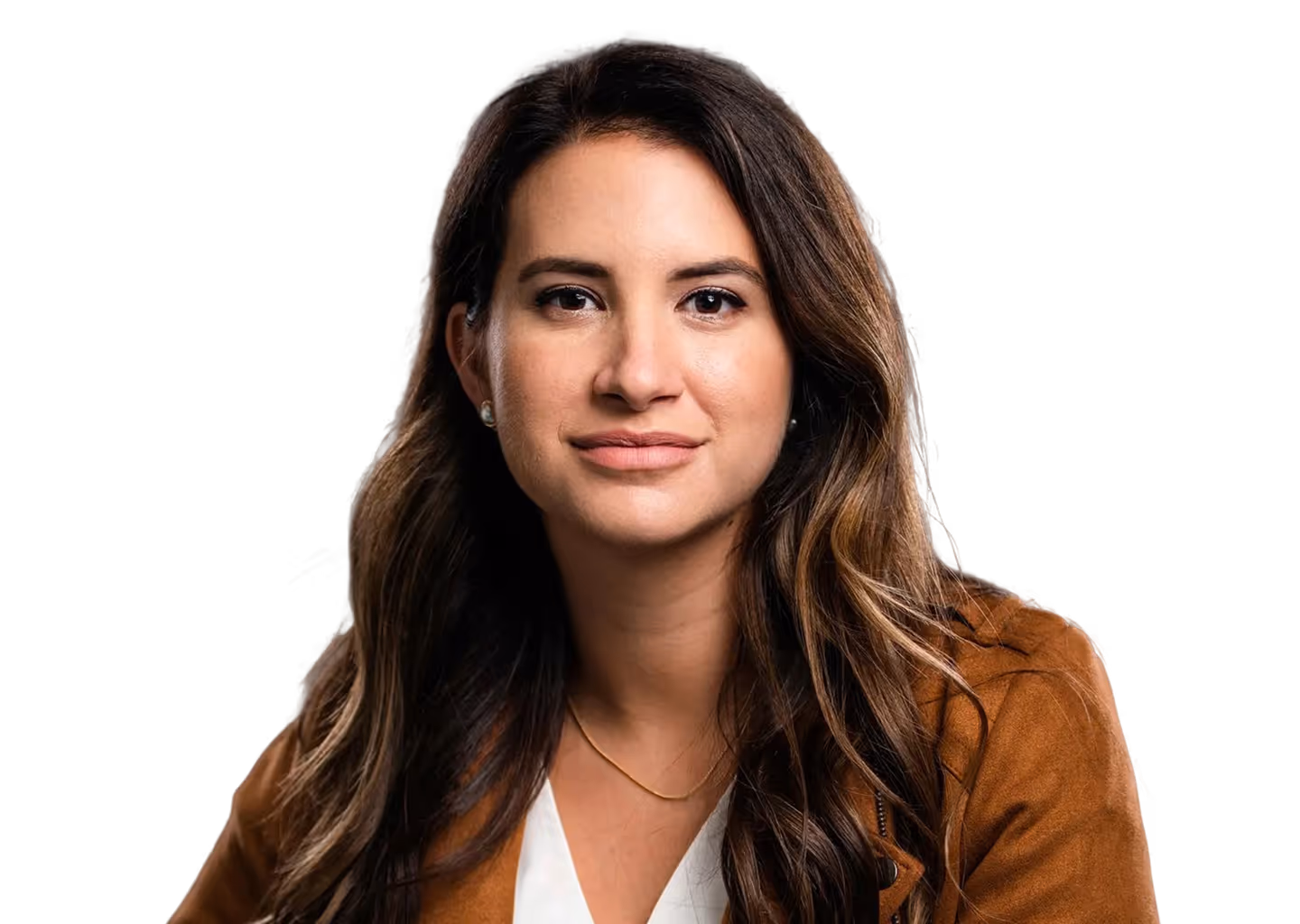 Woman with long brown hair wearing a brown jacket and white top, looking confidently at the camera.
