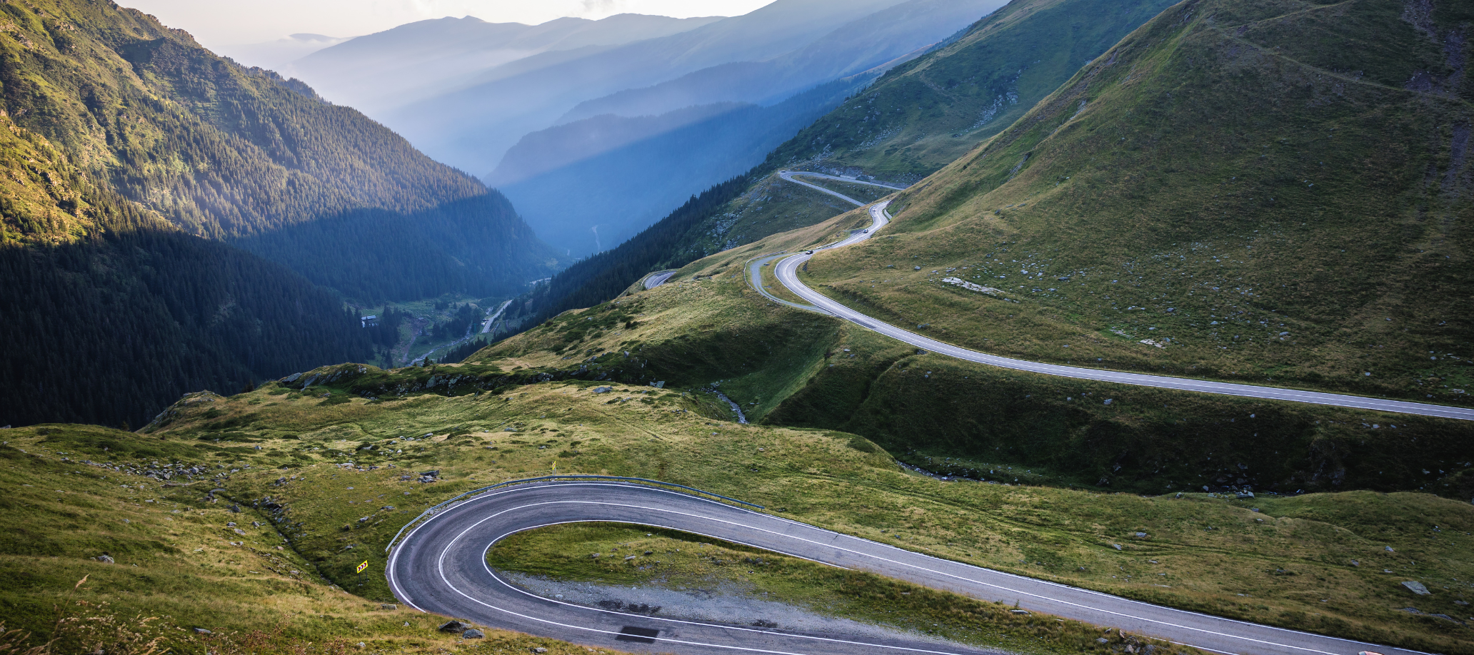 A windy road in a mountain landscape.