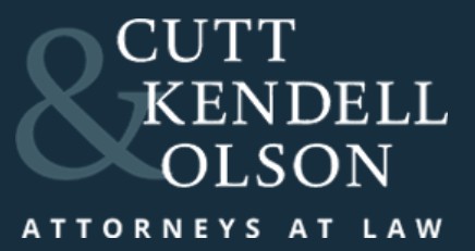 Cutt Kendell Olson Attorneys at Law logo with large ampersand symbol and white text on dark background.